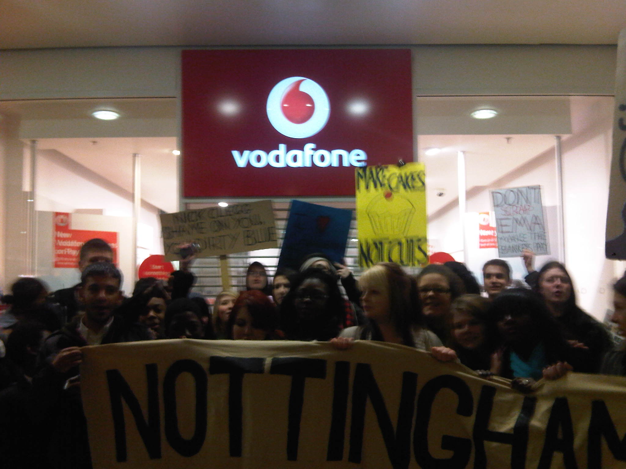 Nottingham students against fees and cuts inside Vodaphone during EMA protest on 11th Jan 2011
